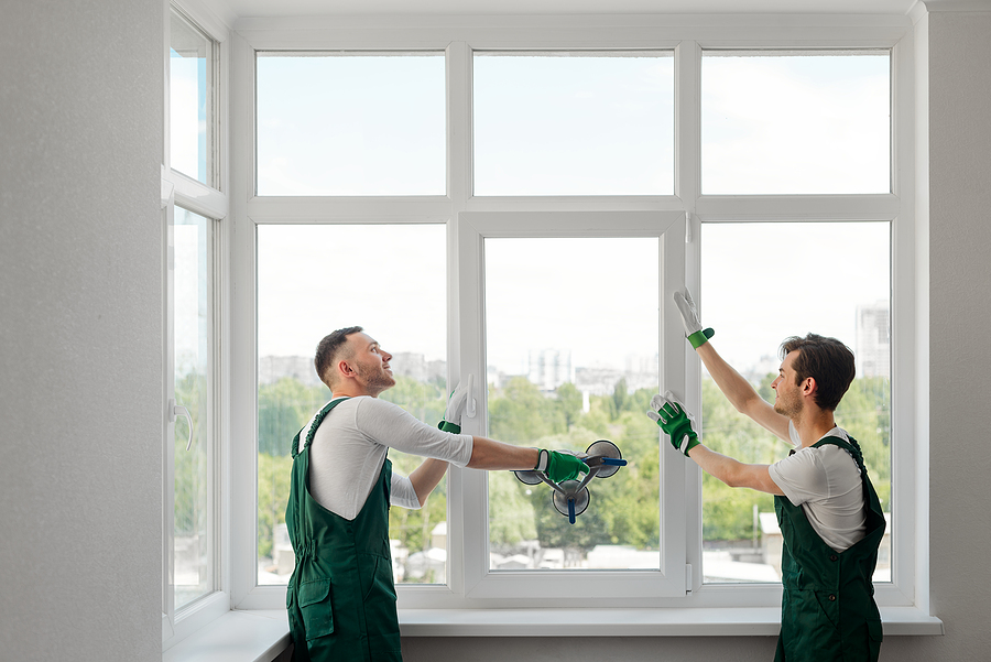 Two Window Installers Replacing A Window In The Living Room